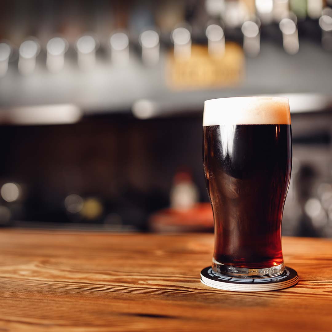 Single craft beer in glass on bar